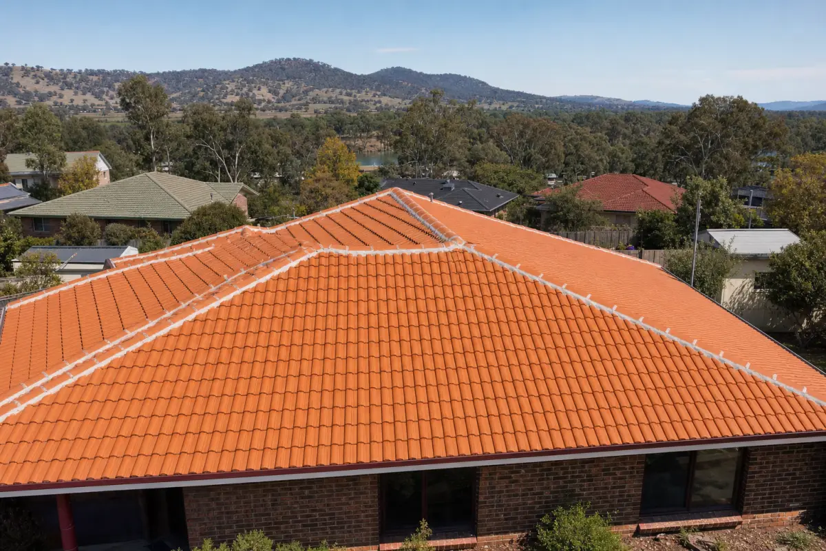 Freshly painted terracotta tile roof on a residential property in Albury and Wodonga — uniform colour, repointed ridge capping