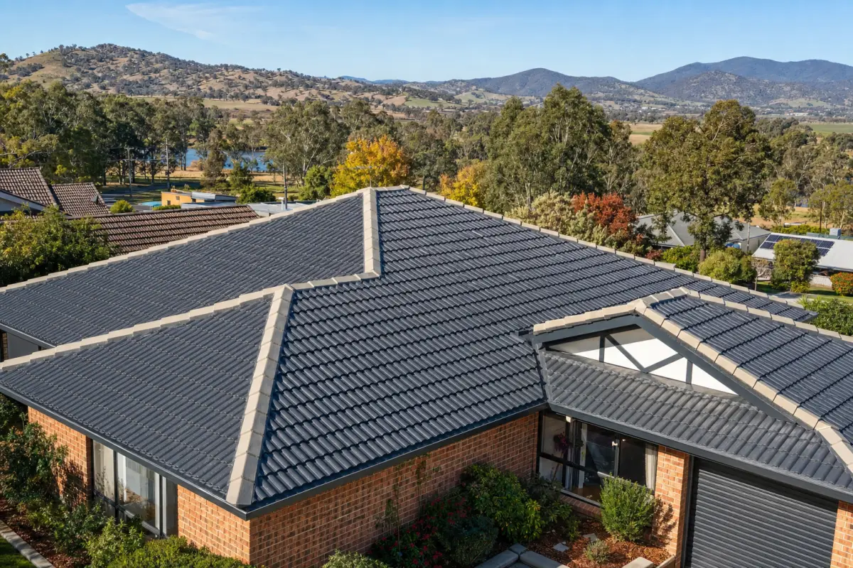 Completed concrete tile roof restoration on a residential property in the Albury and Wodonga region — fresh charcoal coating, repointed ridge capping